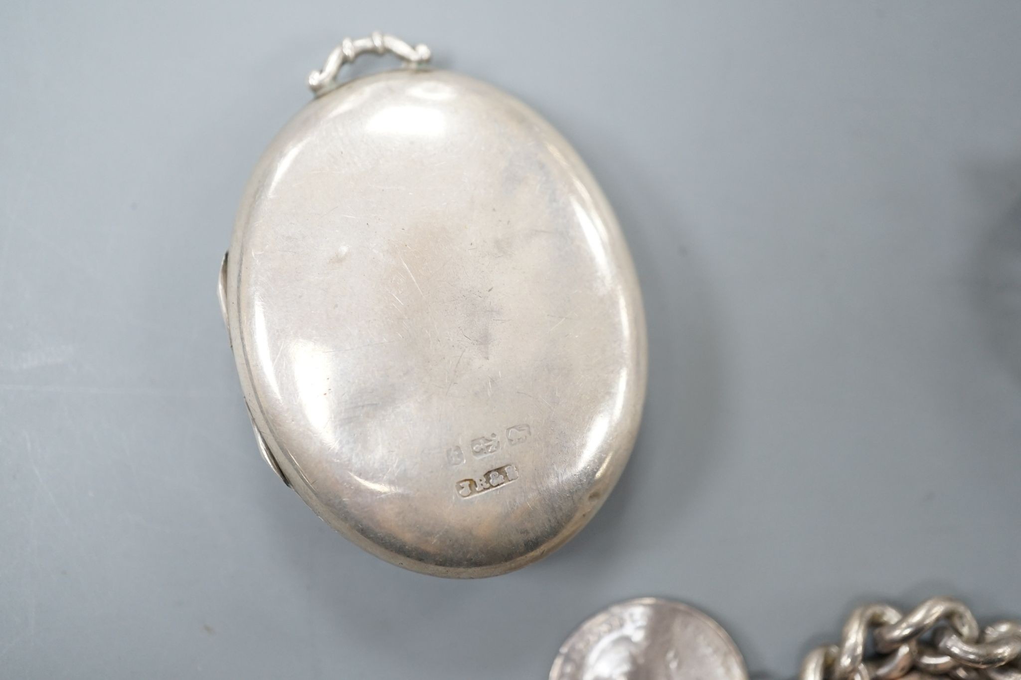 A Middle Eastern yellow metal and gem set pendant, gross 5.9 grams, a silver albert hung with assorted coins and a Victorian silver oval locket.